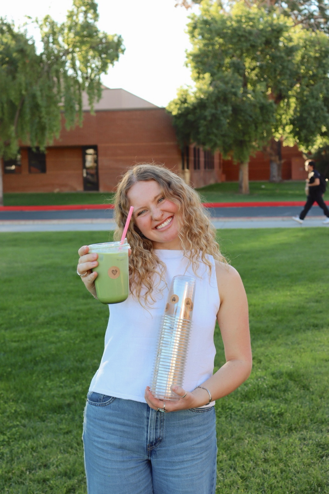 Jessie's matcha drink and cup stack at a pop-up market